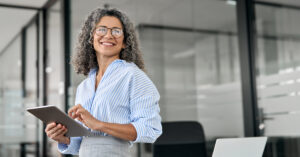Woman smiling holding tablet