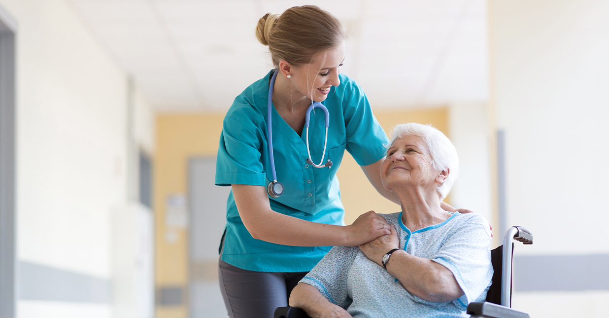 Healthcare worker and elderly patient in wheelchair