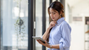 Woman looking at a tablet in a professional setting