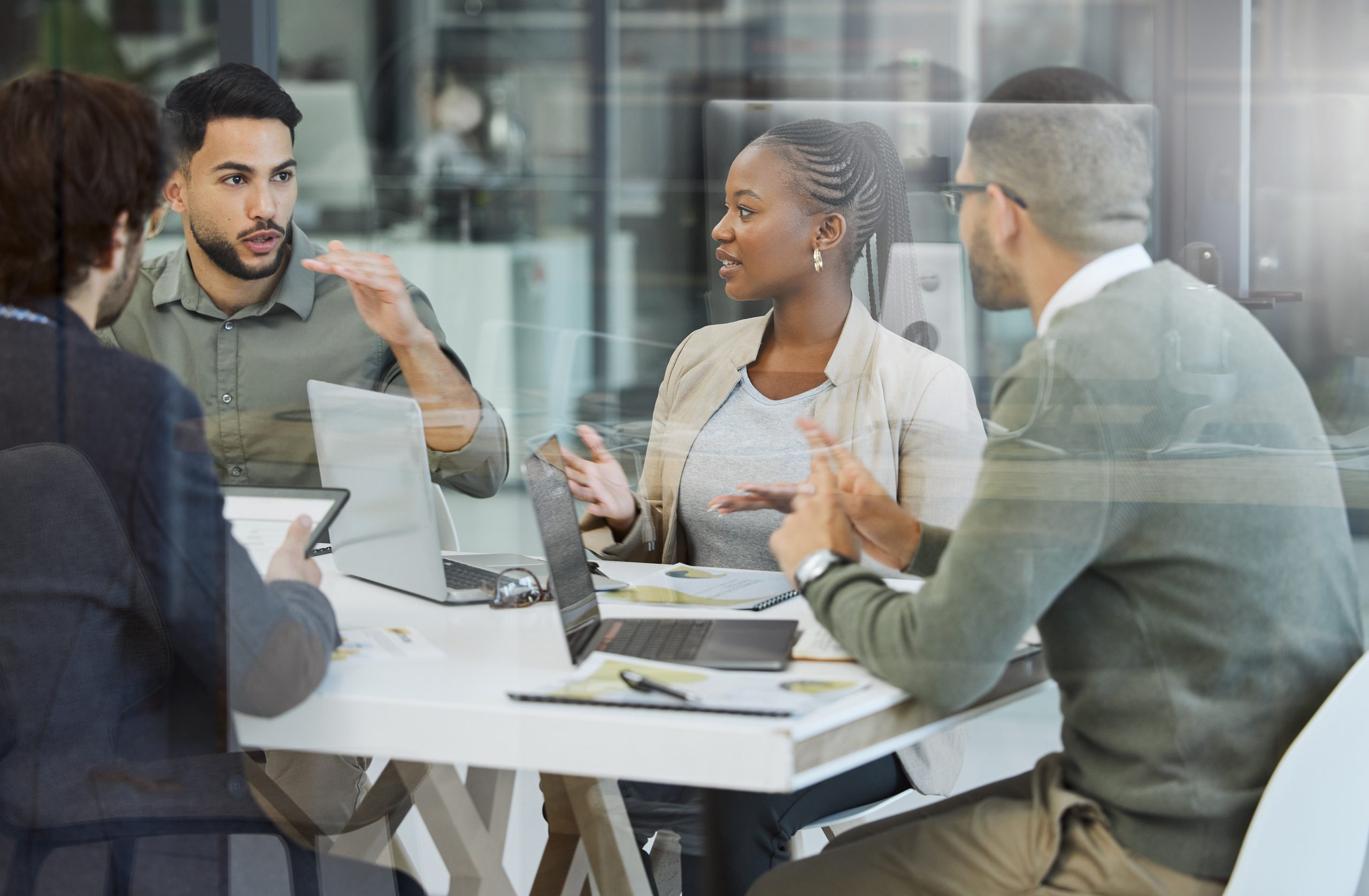 Team of professionals collaborating in a business meeting to discuss healthcare strategy, data insights, and operational performance.